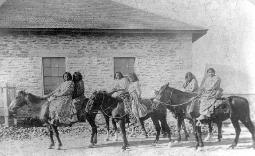 Apache women riding horses with indian jewelry